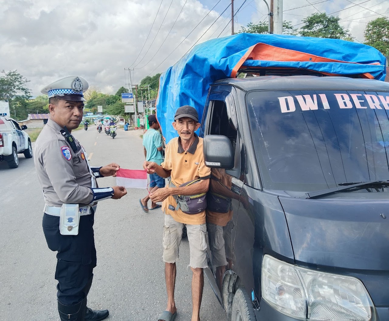 Polres Buton Bagikan Bendera Merah Putih ke Warga